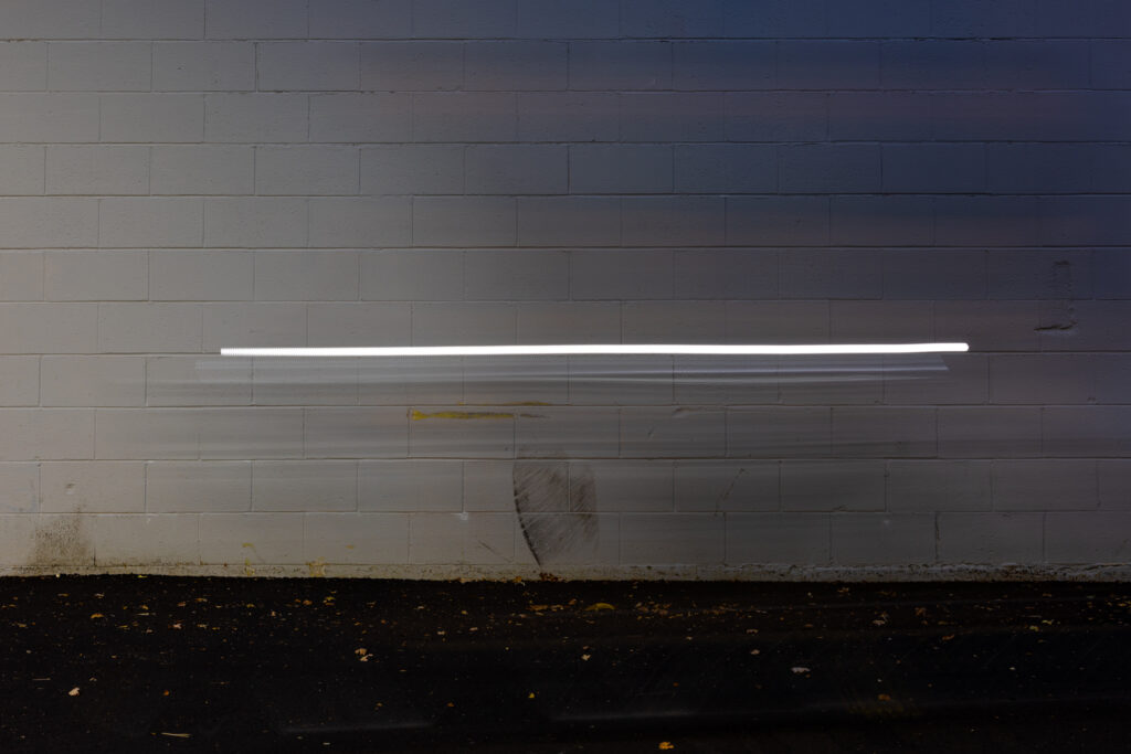 Self portrait on a bicycle early in the morning along a favorite wall